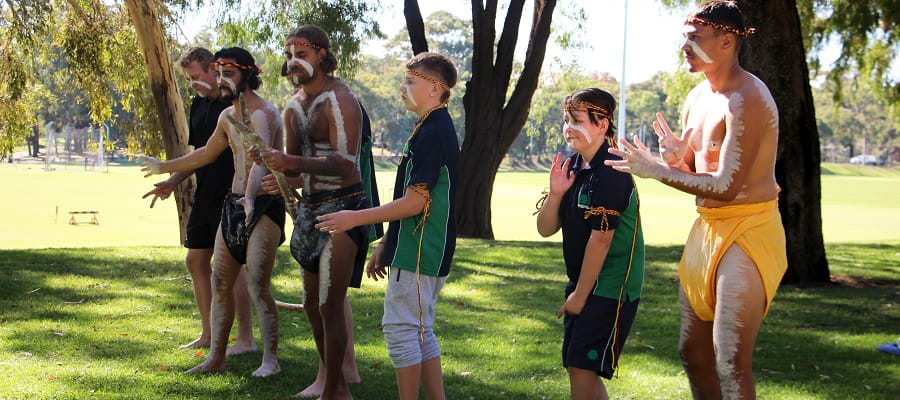 Indigenous boys and men practising a traditional dance