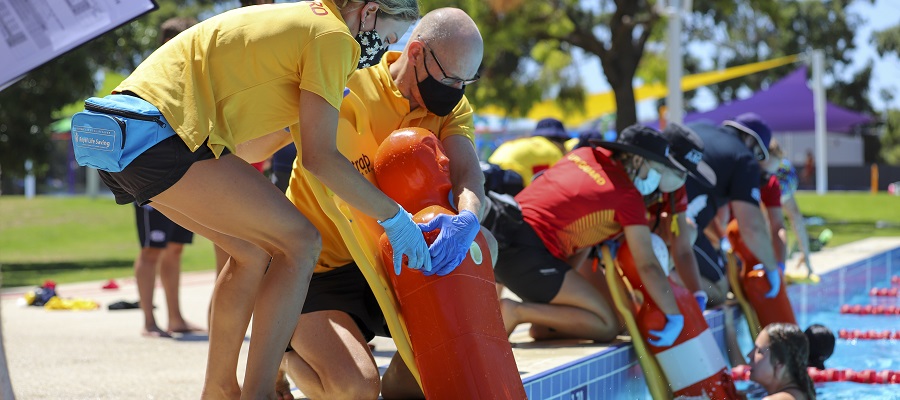 lifeguards practising spinal rescues during the pool lifeguard challenge