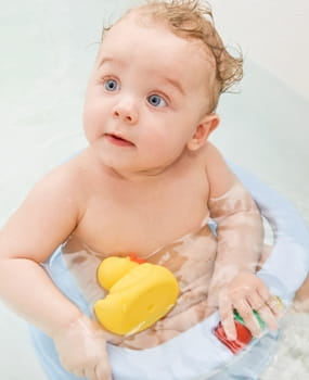 baby in bath with duck