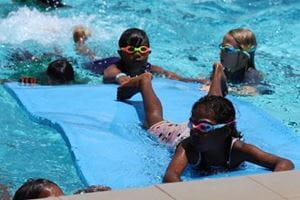 kids on pool mats for the 'magic carpet' race