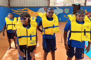 The kids by the pool with lifejackets on