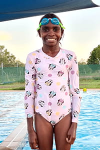 young Aboriginal girl at the pool wearing goggles