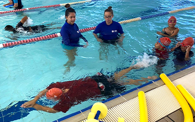 Aboriginal children in the pool with two swim instructors