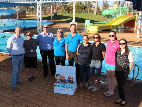 Royal Life Saving Society WA CEO Peter Leaversuch with key stakeholders from across the Pilbara, gathered by the pool at South Hedland Aquatic Centre