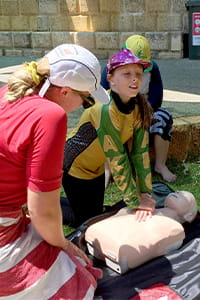 river ready participants applying CPR to a rescue doll 