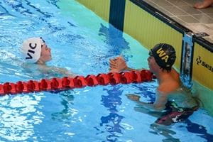 WA and VIC pool lifesaving competitors shaking hands in the pool