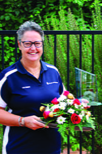 Trainer Isabel Franzoni with flowers and a plaque gift from her students