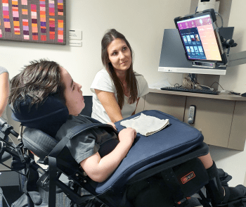 Ari with therapist Yvette Theodorson practising with the Tobii eye tracker system