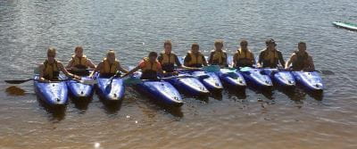 10 participants lined up in kayaks int he Swan River