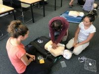 Three people performing CPR