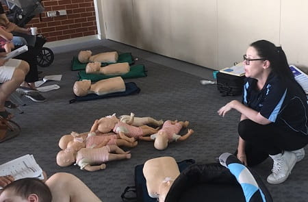 first aid trainer delivering a course to group of people