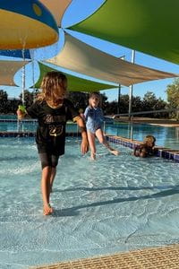 Young Balgo children enjoying the kiddie splash zone at the local pool