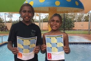 two children from Balgo with their swimming stage certificates