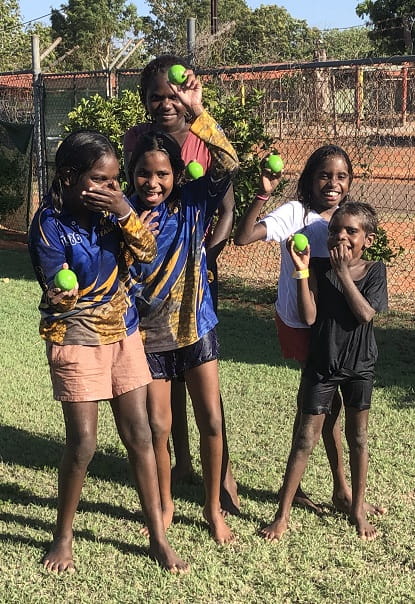 four Aboriginal children holding bouncy balls