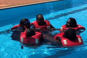 KJ Rangers huddled in a group in lifejackets