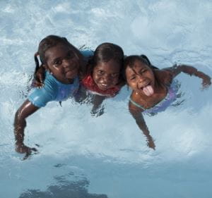 Three indigenous kids play in Bidyadanga pool.