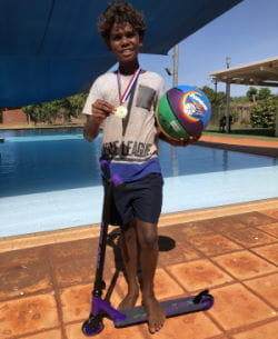 Remarley from Bidyadanga with his scooter, bbasketball and medal for taking part in the Lap Challenge