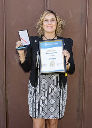 Tania Casotti holding Sam Redfern's Bravery Award