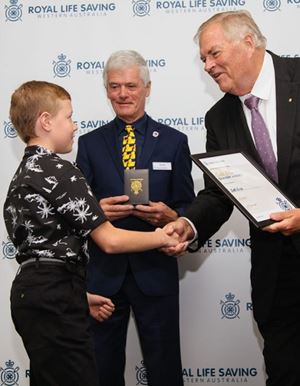 Seth Eade receiving bravery award from WA Governor Kim Beazley AC