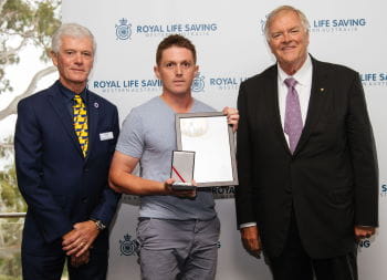 Daniel Crook receiving his Bravery Award from RLSSWA President Colin Hassell and WA Governor Kim Beazley
