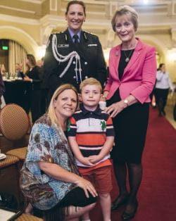 Finnley with his mum Angela, Governor Kerry Sanderson AO and her guard