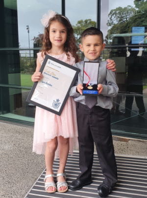 Jayce with his cousin Kortney holding his Bravery Award at Kings Park