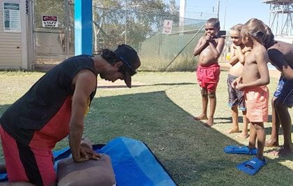 Aboriginal man practising CPR on a manikin