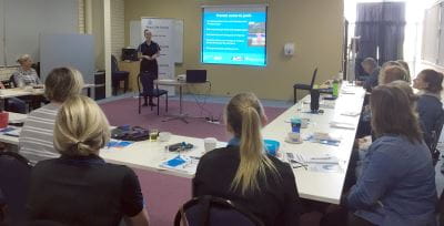 Trainers watching a presentation during their PD session in Bunbury