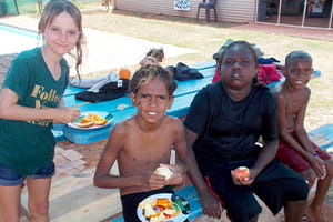 Happy children at Burringurrah eating fruit at the local pool