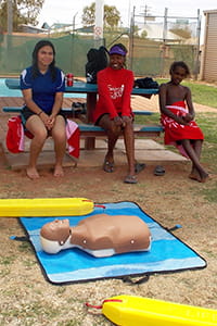 Burringurrah kids sitting near a CPR manikin