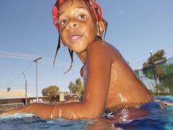 little girl on the side of the pool