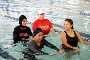 Multicultural women participating in a swimming lesson