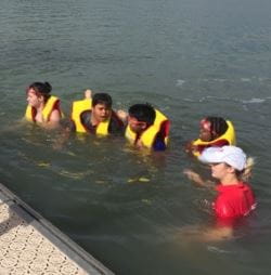 Children wearing lifejackets in the water at Champion Lakes