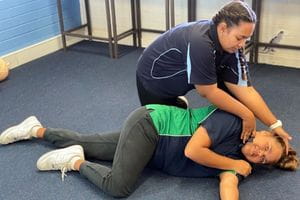 Royal Life Saving trainer Pida Bule-Turner with a Clarkson student demonstrating the recovery position