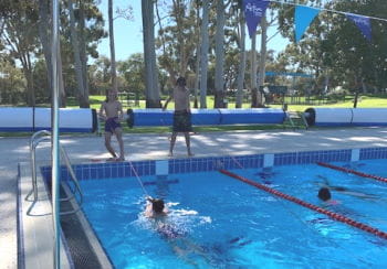 Two boys throwning ropes to their friends in the pool at Armadale Aquatic Centre