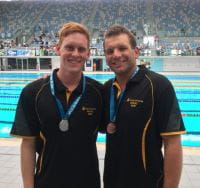 Jake Smith and Adam Moore by the pool with their medals from the Line Throw