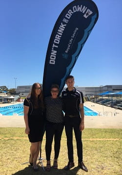 RLSSWA's Lauren Nimmo with Don't Drink and Drown Youth Ambassador Eliza Mitchell and RLSSWA's Joe Down in front of the pool at RLSSWA headquarters
