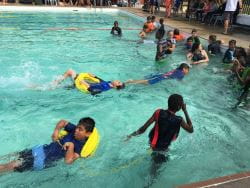 kid being towed in the pool 