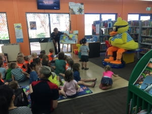 Dippy duck read a story to a large group of kids