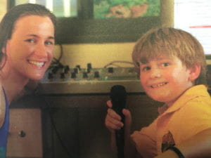 A young Dylan interviewing swimmer Sophie Edington