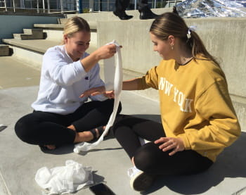 Two young women practising bandaging