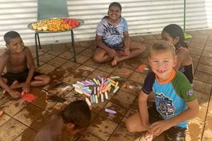Children drawing with chalk at Fitzroy Crossing pool