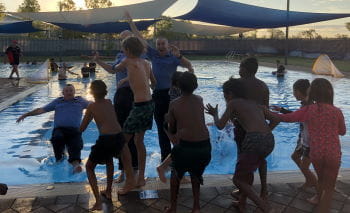 Children pushing police officers into the Fitzroy Crossing Remote Pool