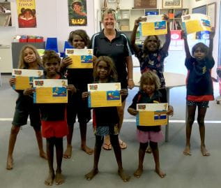 Children from the Fitzroy Valley with Pool Manager Adele Caporn, holding their Swim and Survive certificates
