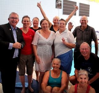Local MLA Mark Folkard with Grey Medallion participants by the pool at Arena Joondalup