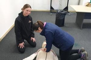 two people practising CPR at a course