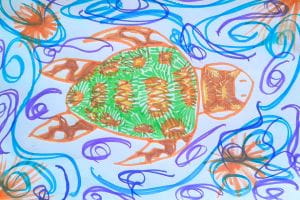 A colourfully patterned turtle drawn on a coloured swirls background