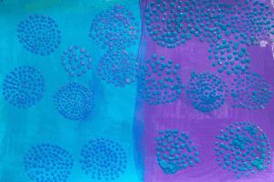 Dark blue dots painted onto a split blue and purple background