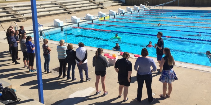 Swim School Coordinators by the pool completing practical PD