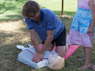 A person practising CPR on a manikin